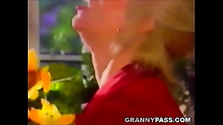 Golden-haired mature lady indulges in wild anal sex with younger lover, relishing every moment.